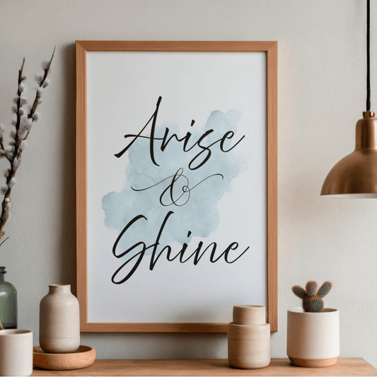 Printable artwork with 'Arise & Shine' text on a shelf with decorative items.